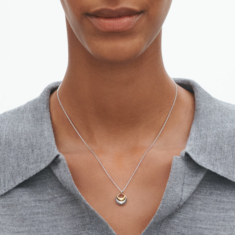 Silver and 18ct gold curve pendant by Georg Jensen at Owen & Jones